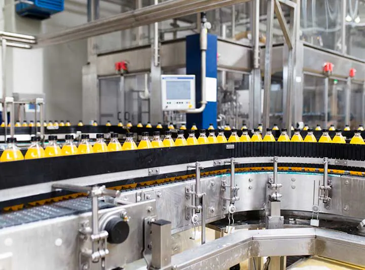 Juice bottles on a curved conveyor